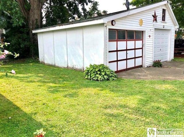 garage featuring a lawn