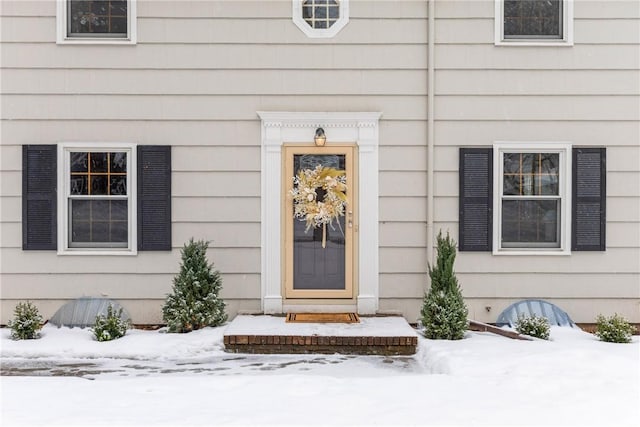 view of snow covered property entrance