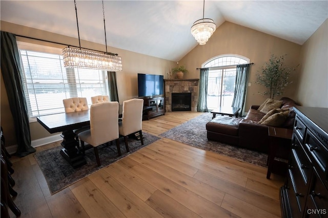 1771 Independence, Utica, NY 13502 - dining room with baseboards, an inviting chandelier, hardwood / wood-style flooring, a fireplace, and high vaulted ceiling