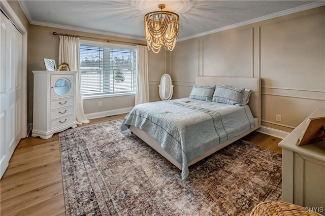 1771 Independence, Utica, NY 13502 - bedroom featuring crown molding, a decorative wall, light wood-style flooring, a chandelier, and baseboards
