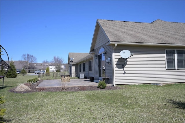 1771 Independence, Utica, NY 13502 - view of side of home with a patio, a shingled roof, and a lawn