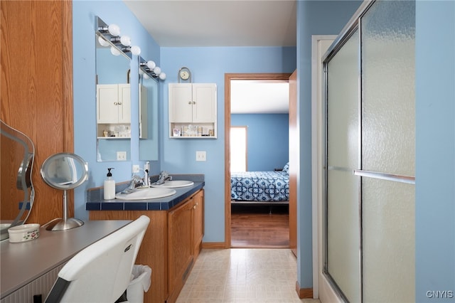 bathroom with vanity and a shower with shower door