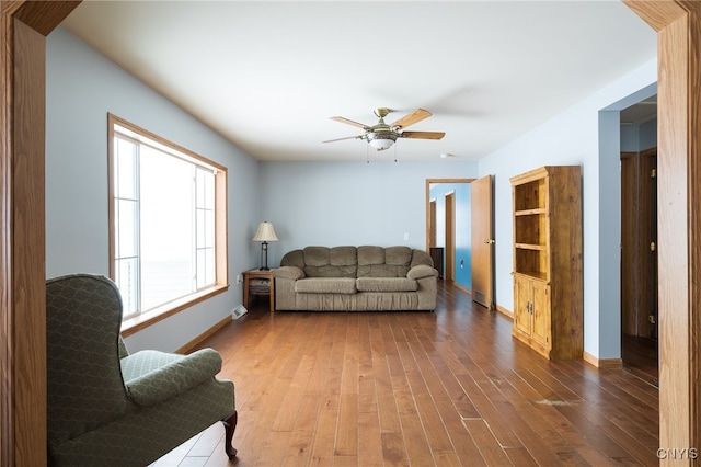 living room featuring wood-type flooring and ceiling fan