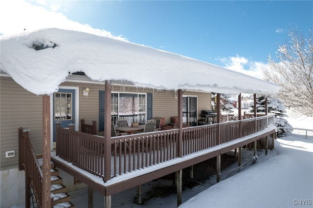 view of snow covered rear of property