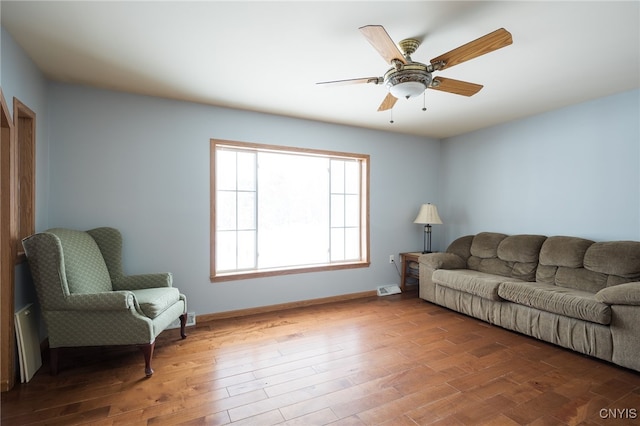 living room with ceiling fan and wood-type flooring