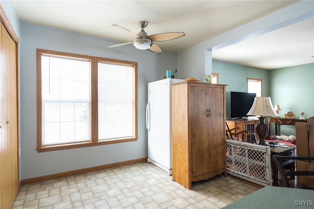 kitchen featuring ceiling fan, plenty of natural light, and white fridge