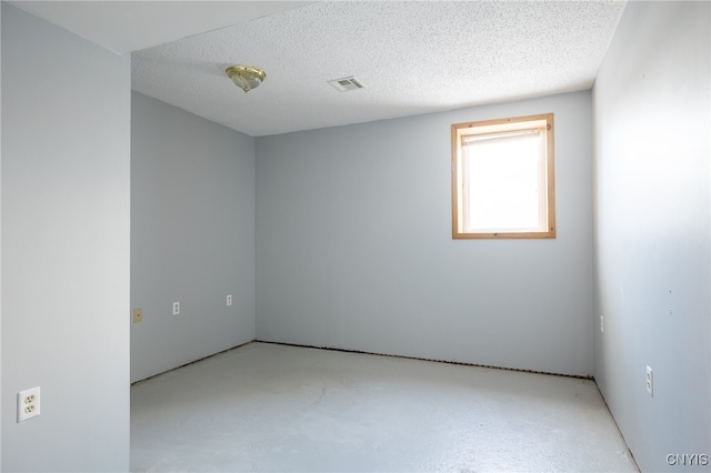 empty room with a textured ceiling