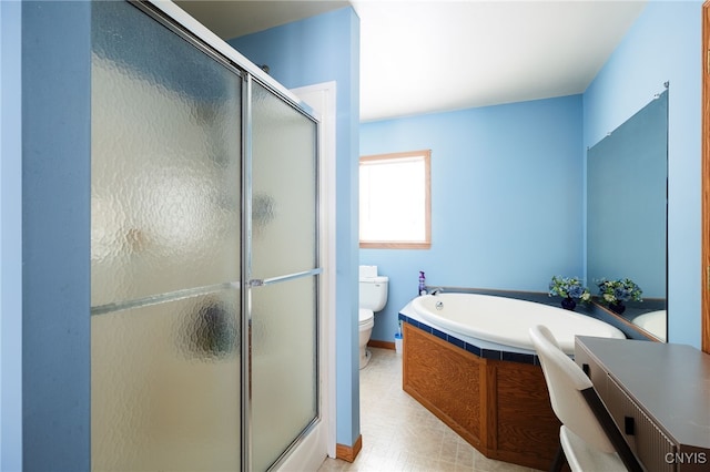 bathroom featuring toilet and separate shower and tub