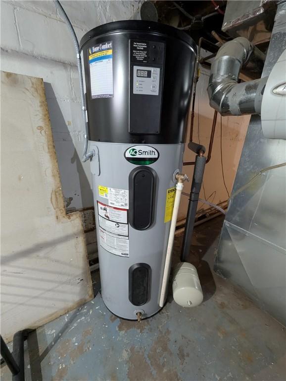 utility room featuring hybrid water heater