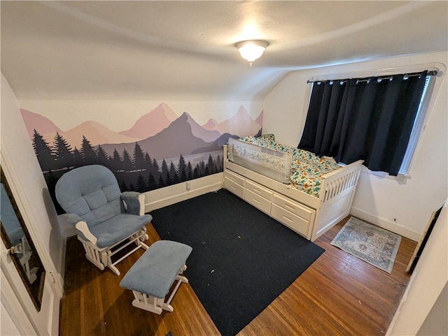 bedroom with dark wood-type flooring and vaulted ceiling