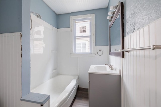 bathroom with vanity, wood-type flooring, and a washtub