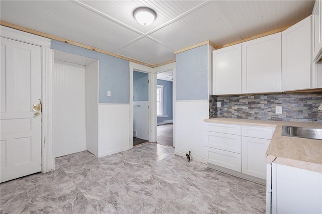 kitchen featuring white cabinetry, sink, and decorative backsplash