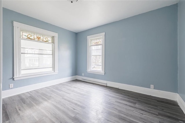 unfurnished room with hardwood / wood-style flooring