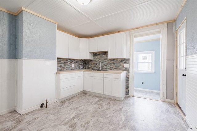 kitchen featuring sink and white cabinets