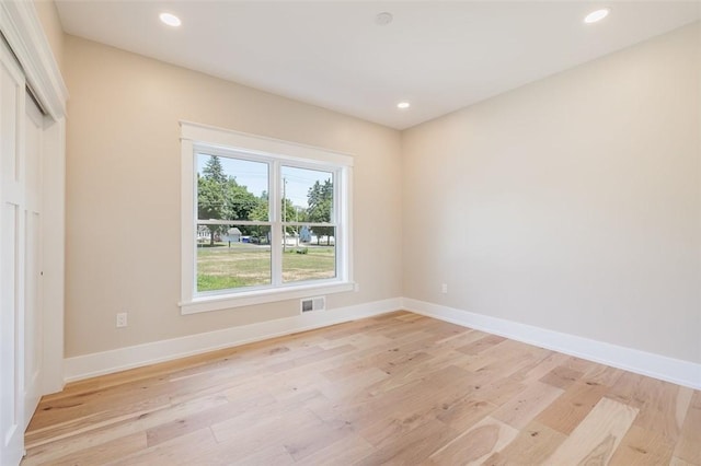 empty room with light hardwood / wood-style flooring