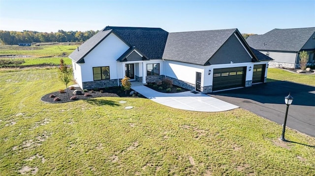 modern farmhouse style home featuring a garage and a front yard