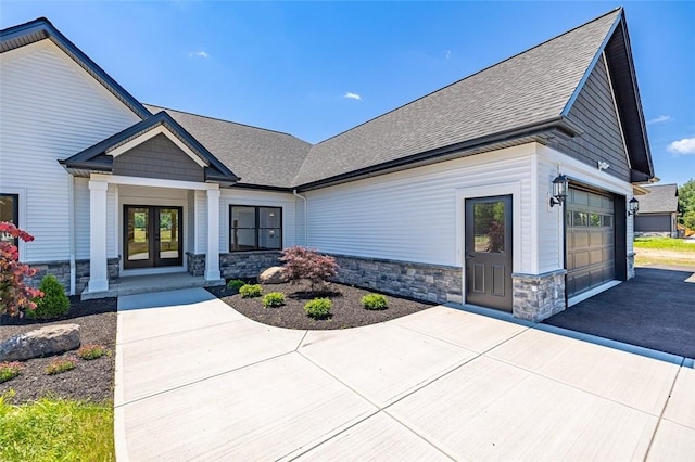 view of front of property with a garage and french doors