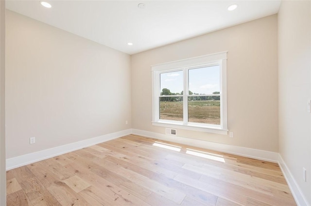 spare room with light hardwood / wood-style floors