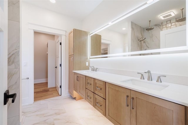 bathroom featuring walk in shower and vanity