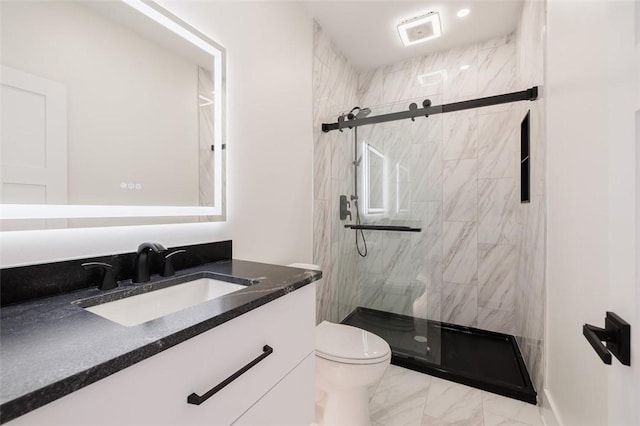 bathroom with vanity, a shower with shower door, and toilet