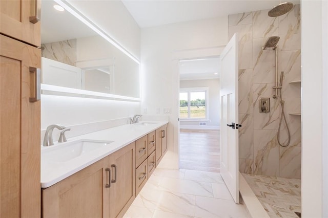 bathroom with vanity and tiled shower