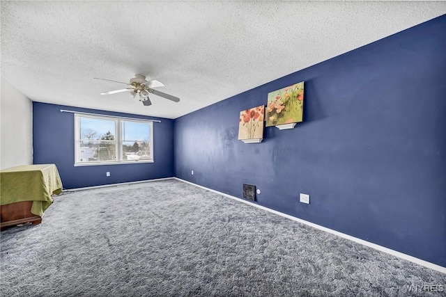 unfurnished bedroom with ceiling fan, carpet flooring, and a textured ceiling