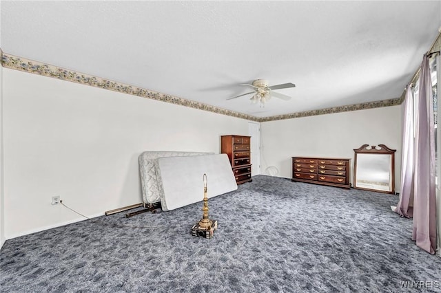 unfurnished bedroom featuring carpet, a textured ceiling, and ceiling fan