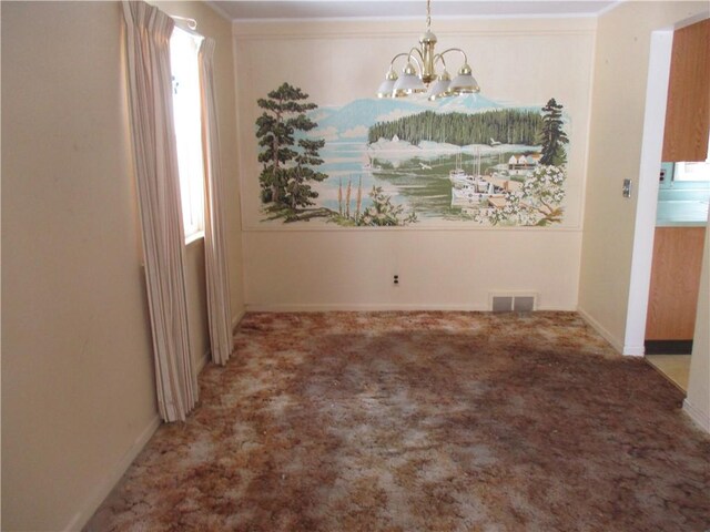 unfurnished dining area with crown molding, carpet, and an inviting chandelier