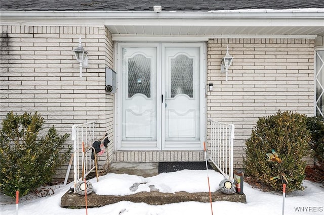 view of snow covered property entrance