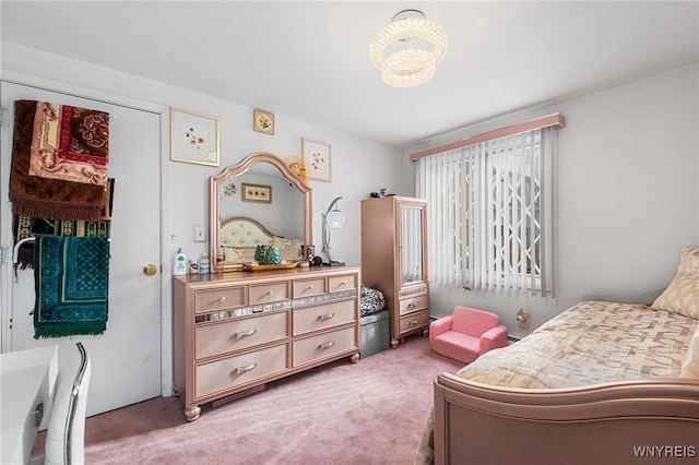 bedroom featuring a chandelier and carpet flooring