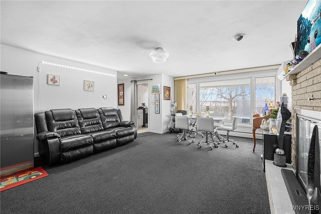 living room featuring a brick fireplace