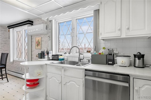 kitchen with white cabinetry, dishwasher, sink, a wall mounted AC, and a baseboard heating unit