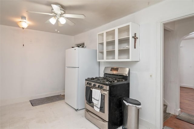 kitchen with white cabinetry, ceiling fan, white refrigerator, and gas stove