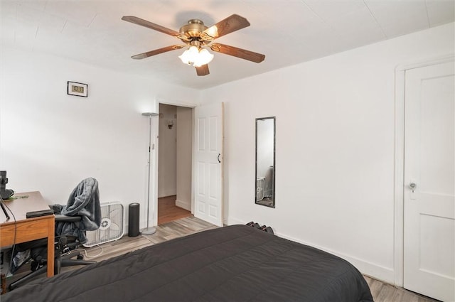 bedroom with light hardwood / wood-style flooring and ceiling fan