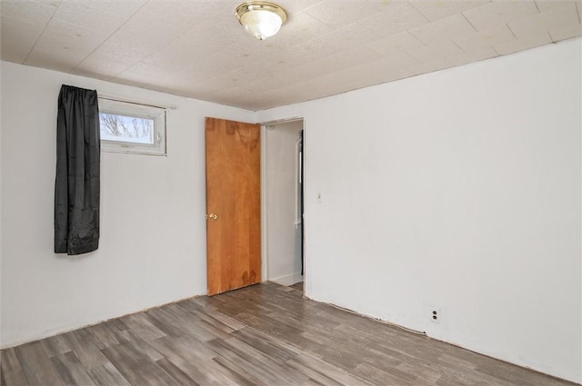 spare room with hardwood / wood-style floors