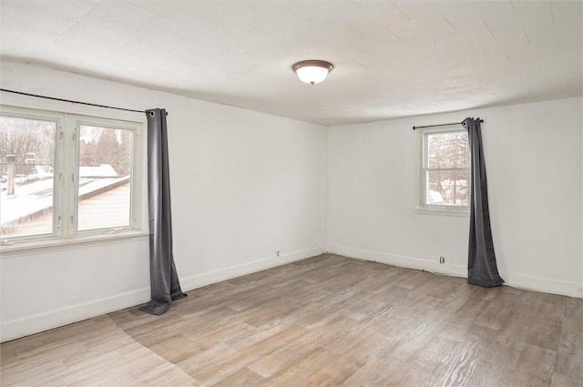 unfurnished room with light hardwood / wood-style flooring