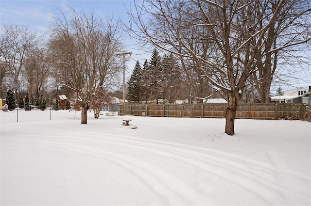 view of yard layered in snow