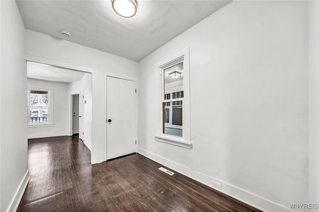 unfurnished room with dark hardwood / wood-style floors