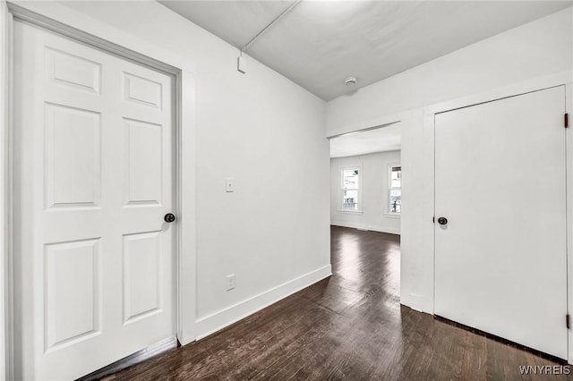 corridor with dark hardwood / wood-style floors