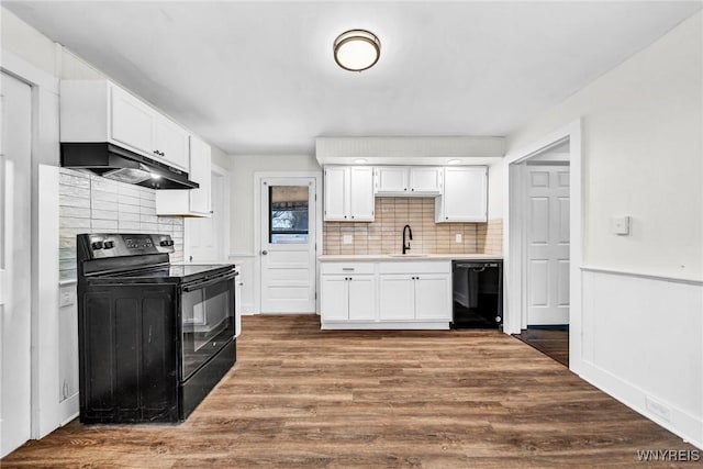 kitchen featuring white cabinetry, sink, extractor fan, and black appliances