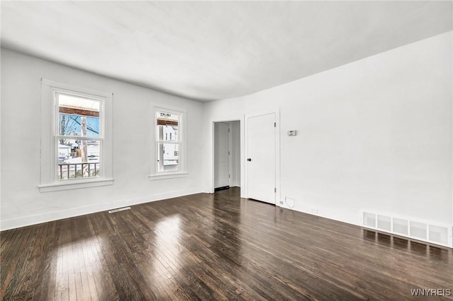 empty room with dark hardwood / wood-style flooring