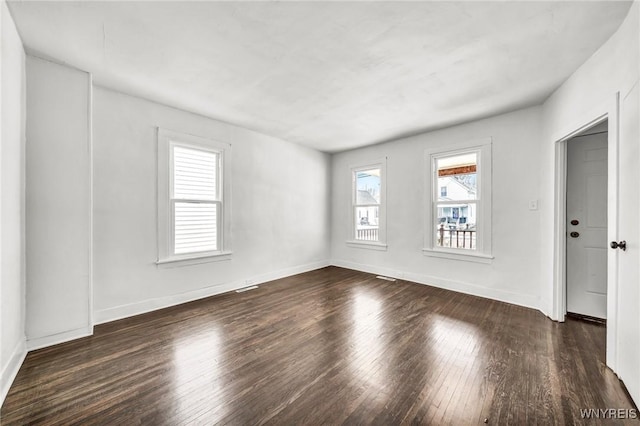 spare room with dark wood-type flooring