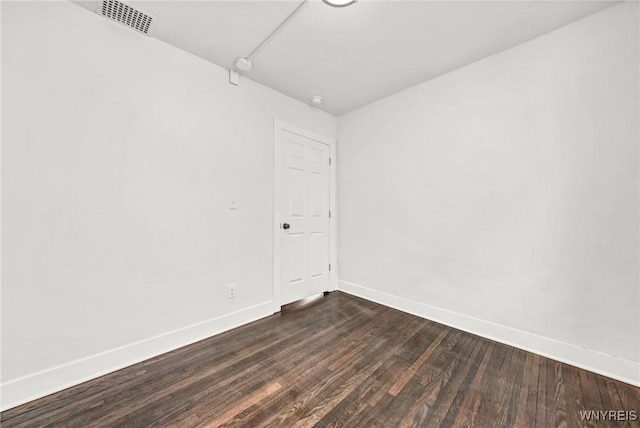 empty room featuring dark wood-type flooring