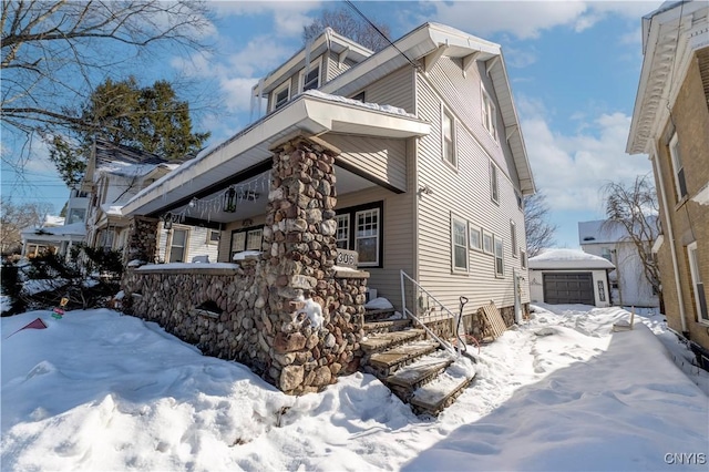 view of front of house featuring a garage and an outdoor structure