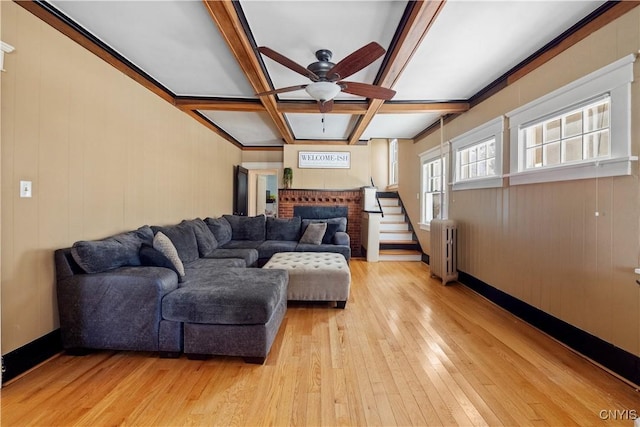 living room with coffered ceiling, light hardwood / wood-style flooring, radiator heating unit, beamed ceiling, and ceiling fan