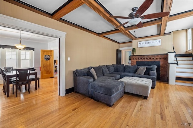 living room featuring ceiling fan, coffered ceiling, beam ceiling, and light hardwood / wood-style flooring