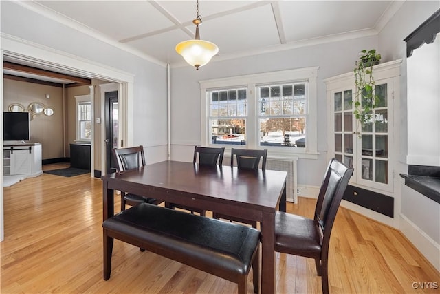 dining space featuring ornamental molding and light hardwood / wood-style floors