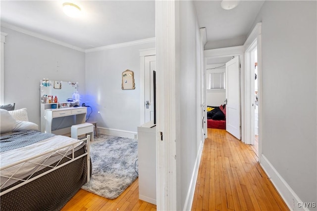 bedroom with wood-type flooring and ornamental molding