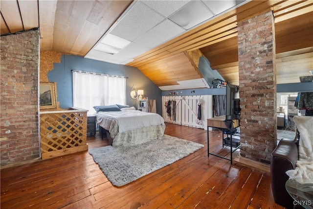 bedroom featuring vaulted ceiling and dark hardwood / wood-style flooring