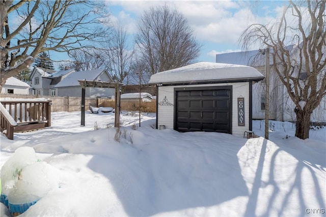 yard layered in snow featuring a garage